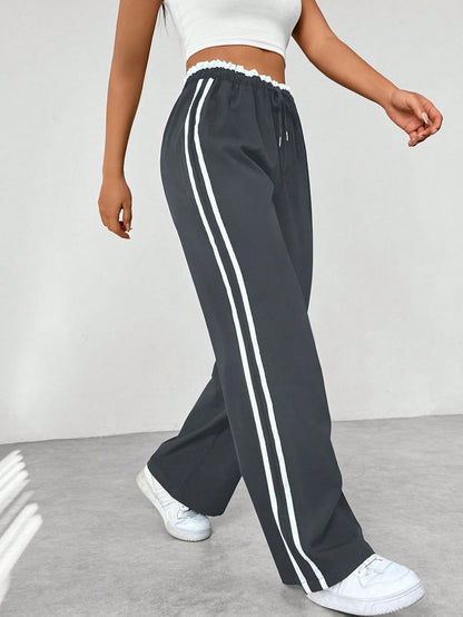 Pantalon de running femme noir et blanc à rayures contraste