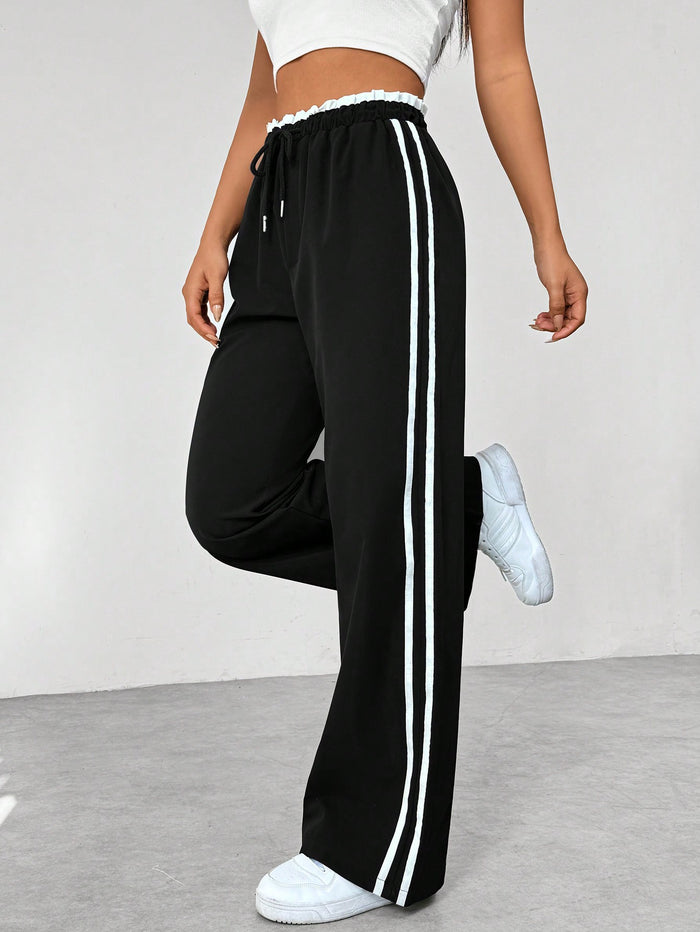 Pantalon de running femme noir et blanc à rayures contraste